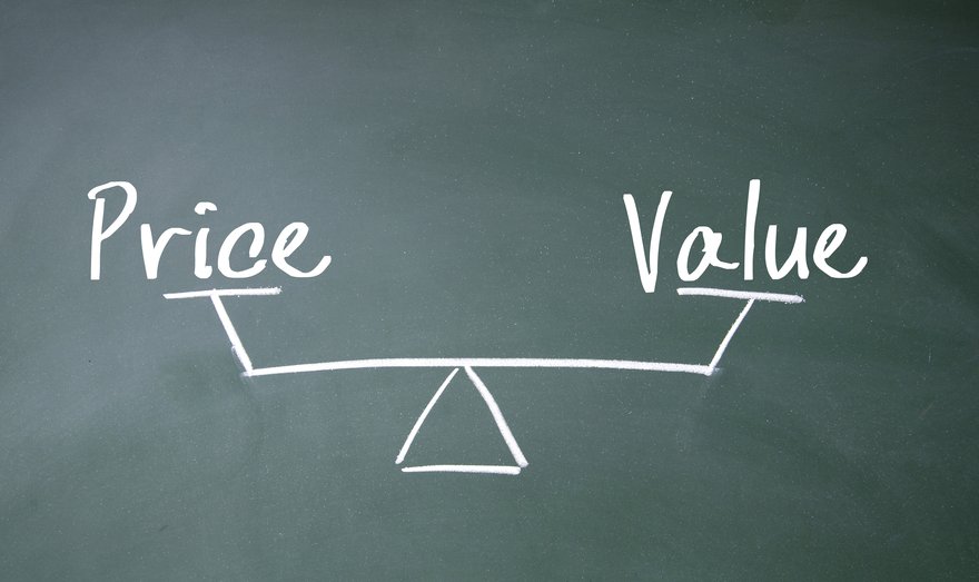 The words Value and Price at opposite ends of a balance drawn on a blackboard.