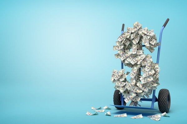A hand truck moving a large dollar sign shape made of floating dollar bills.